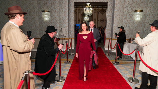 Paparazzi greet gala guests as they walk the red carpet into the reception