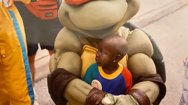 child sitting with disney character 