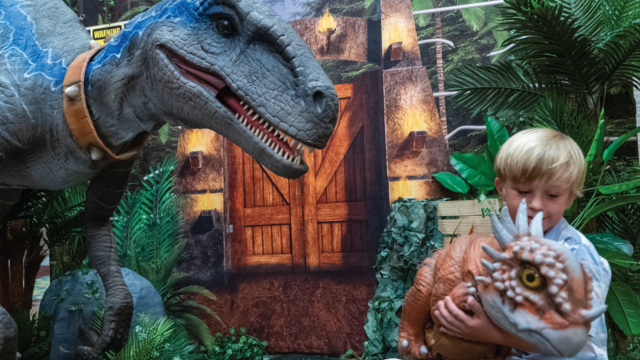 Dean holds a dyne baby at his Jurassic reveal at Waffles & Wishes!