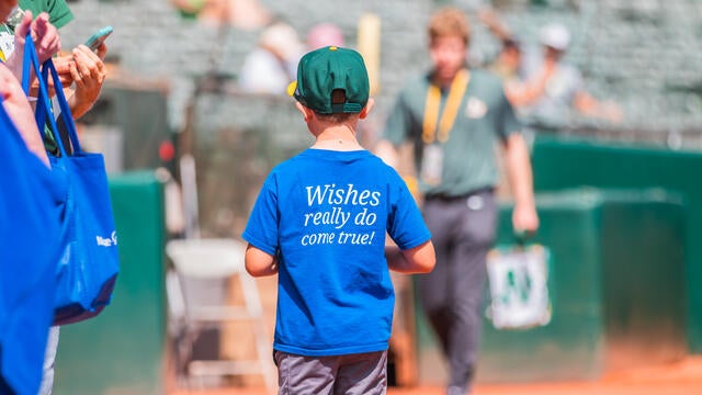 Wish kid walking the field at Make-A-Wish Day at the A's.