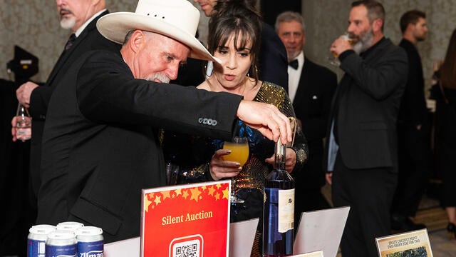 Guests peruse the silent auction at the 2024 Evening of Wishes: Birthday Bash.