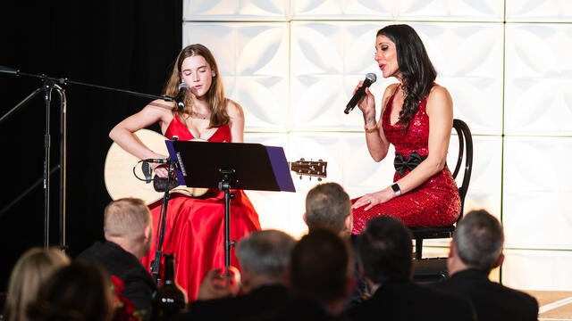 Wish alum Sophie performs an original song with back up from auctioneer Ellen Toscano.