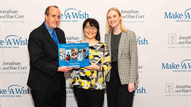 Senior Volunteer Manager Daniel Marlay, milestone volunteer NaSun Cho, Volunteer & Governance Associate Kaitlin Doolittle honoring NaSun with her volunteer milestone plaque at our Evening of Wishes Birthday Bash. 