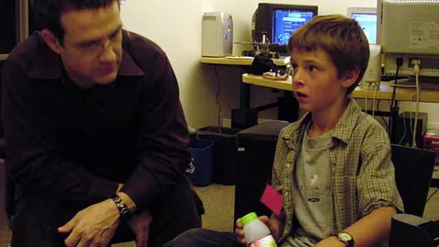 Ben with a bottle of limeade hashing out game concept ideas with EJ in EJ's office at LucasArts in 2004.  