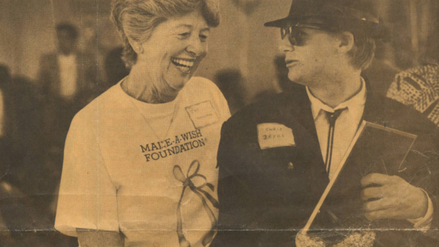 Former wish kid Chris with Pat Probert in 1991, showing her a photo of his wish.