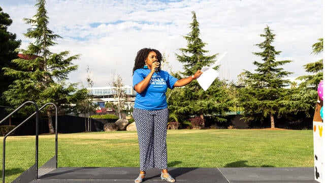 Reyna Harvey from KRON4 stands on stage at Walk for Wishes