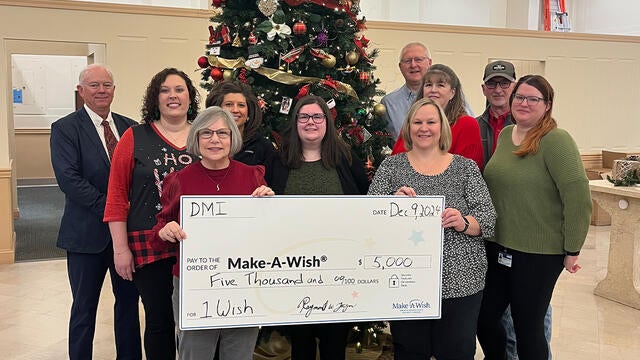 Pictured here are DMI employees presenting a donation to Stephanie Pugliese, Make-A-Wish director of development.