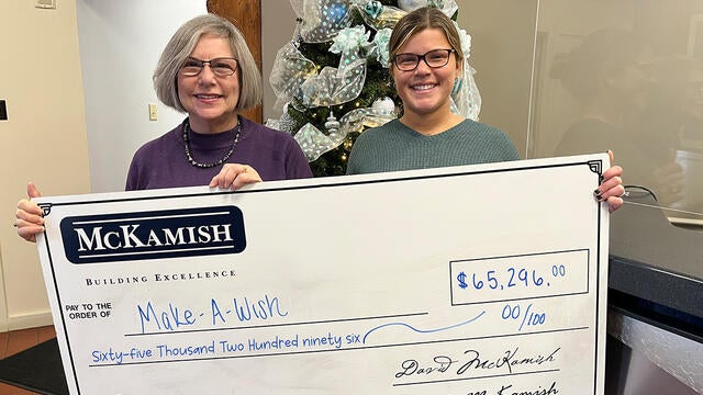 Naley McKamish, director of marketing presenting a $65,296 donation to Stephanie Pugliese, Make-A-Wish Director of Development.