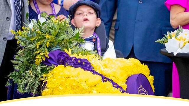 Wish kid Cody Dorman sits draped with honors at the Breeder's Cup Dirt Mile race.