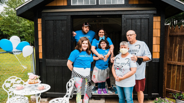 Abby and family in front of her she-shed
