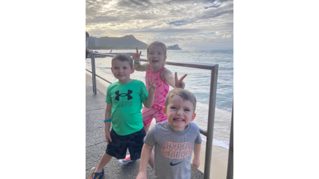 Wish kid Aileen with her brothers, posing at sunset in Hawaii