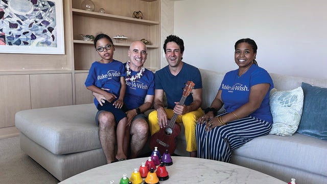 Atticus and his parents taking a picture with Mr. Rob