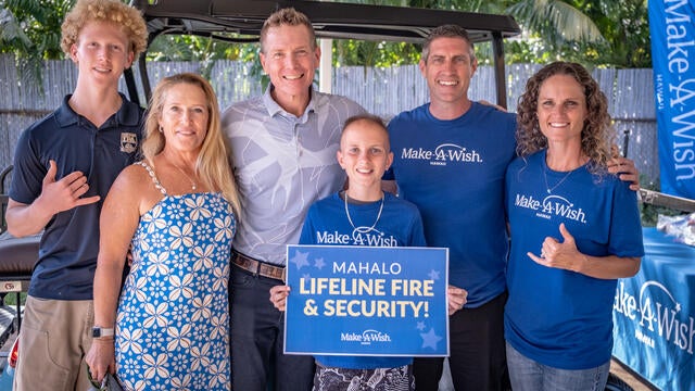 Kainoa, his parents, Todd Beddford, and his family taking a picture in front of his new golf cart