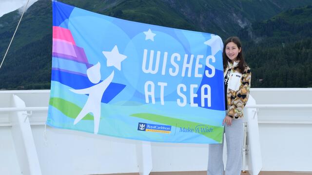 Rachael holding "Wishes at Sea" sign