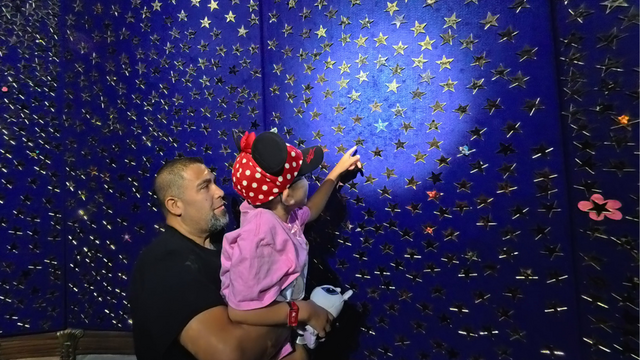 Valentina putting star on wall at Give Kids the World