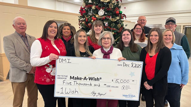 Pictured here are DMI employees presenting a donation to Stephanie Pugliese, Make-A-Wish director of development.