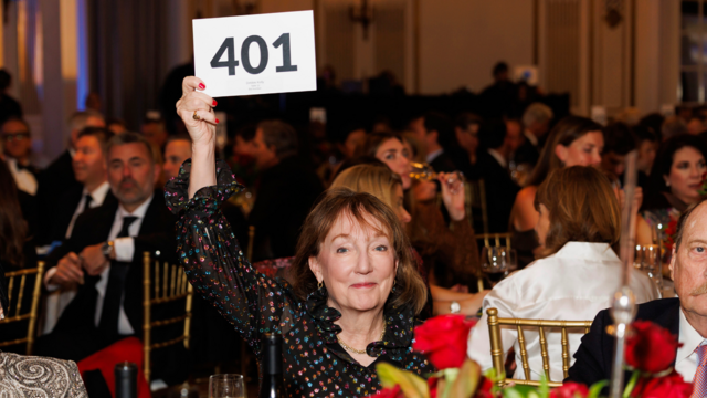 Debbie Kelly raising her bid paddle