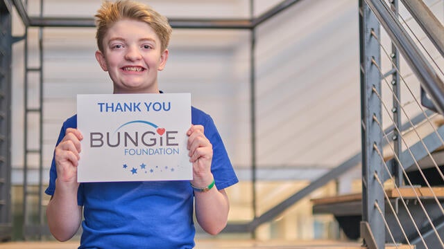 Wish Kid Alex holding Bungie Sign