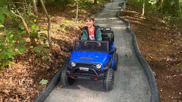 Wish kid Teddy in a toy car