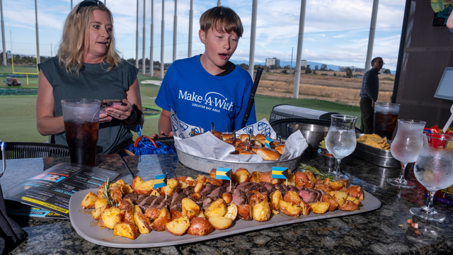 Wish kid Leland enjoys his favorite foods during his wish sendoff celebration at Topgolf