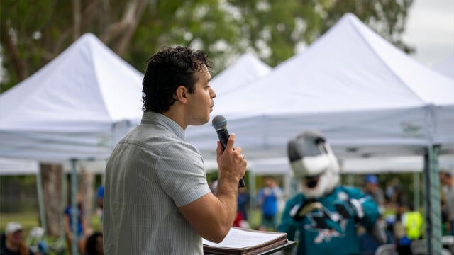 Los Gatos Mayor Rob Moore addresses the Walk crowd with Sharkie in the background