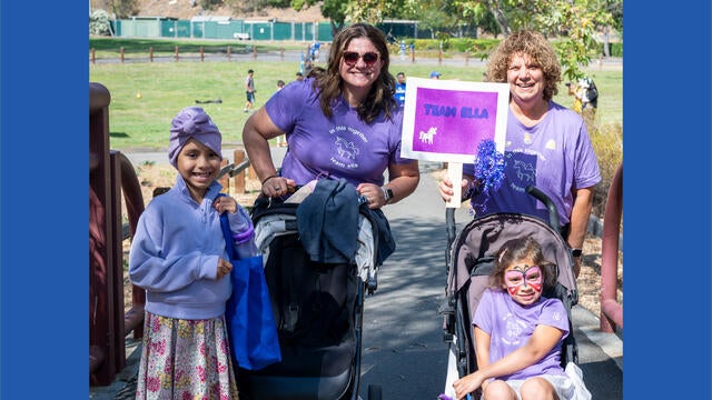 Team Ella, a family, pose at the finish line of the course