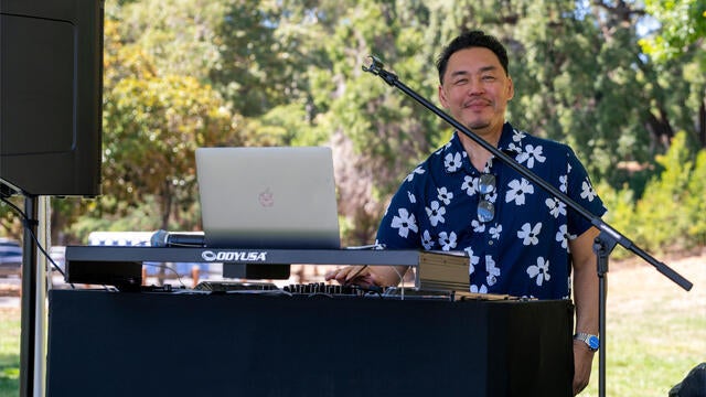 DJ Rob at the DJ booth on stage